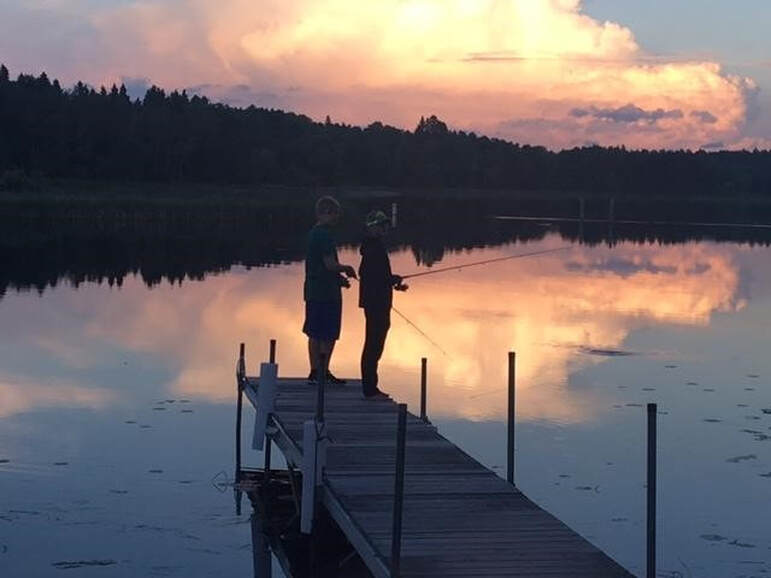 fishing at sunset on the dock at Cut Foot Sioux Resort